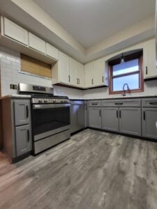 20230208_173640 Modern kitchen remodel featuring new cabinets, countertops, and lighting fixtures