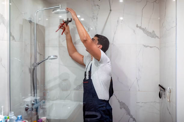 plumber at work in a bathroom, plumbing repair service, assemble and install concept Home Overhaul team upgrading bathroom shower