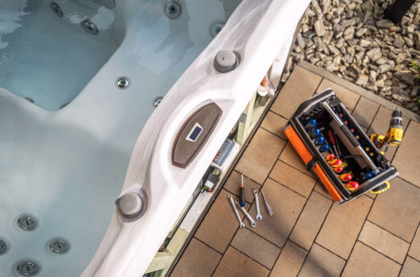 Tools scattered on a hot tub. Garden SPA repair theme. modern Jacuzzi bath remodel enhancing comfort in Hudson